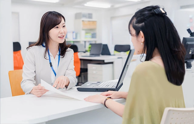 Foreign business client receiving assistance with corporate bank account opening in Singapore, guided by Yobbi representative