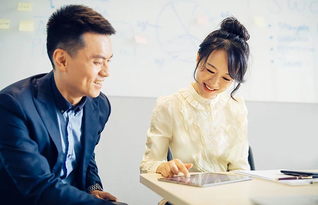 Business professionals in a face-to-face meeting discussing company registration in Singapore