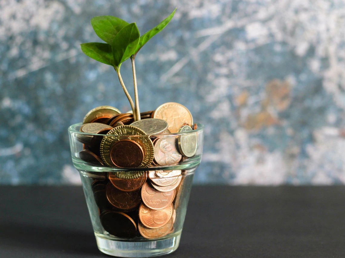 A money pot with coins, symbolizing savings or financial planning for school fees.