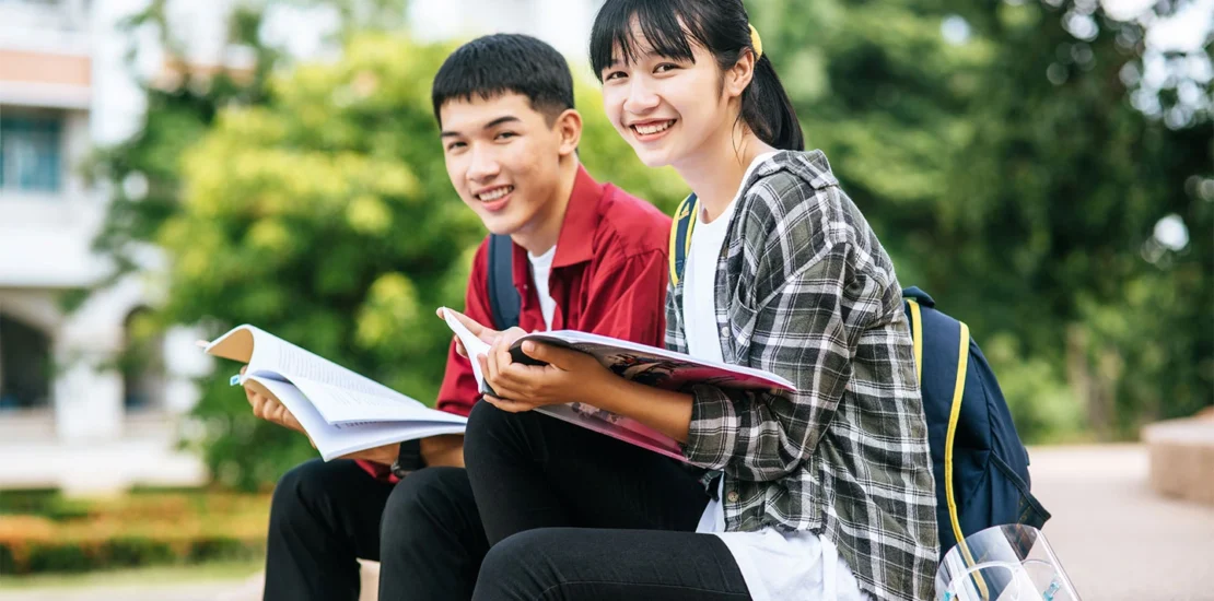 Two international students arriving in Singapore with their student visas to begin their studies.