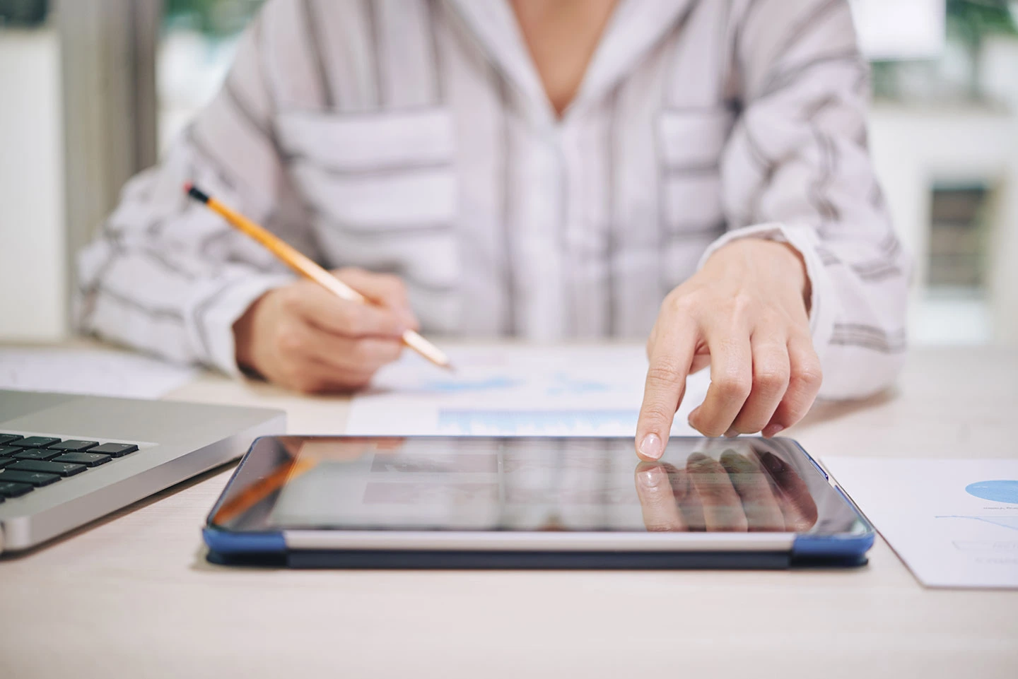 Woman using a tablet to check the admission deadline for a school application.