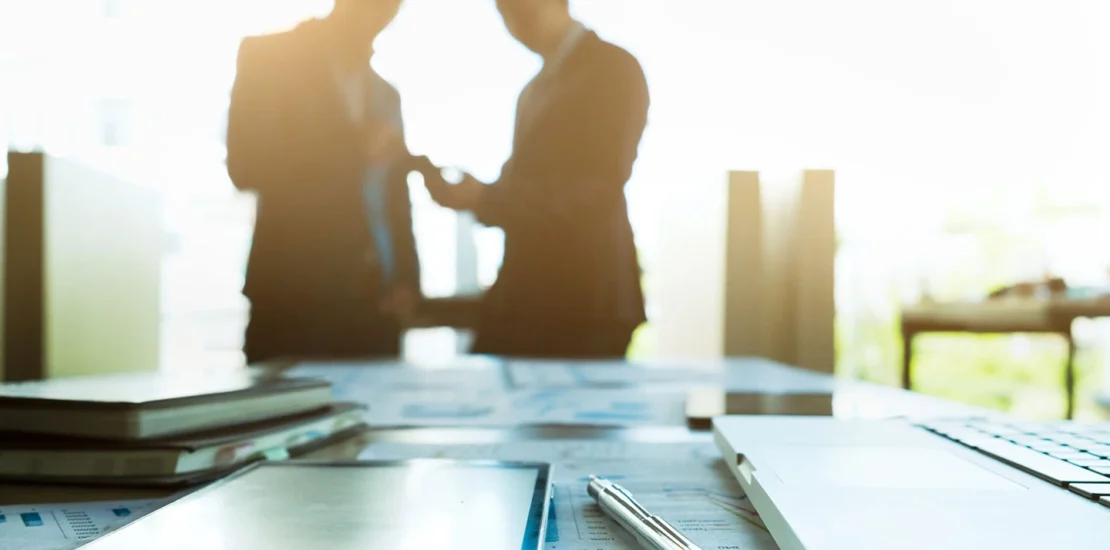 Team partners collaborating in an office setting for Singapore Employment Pass application.