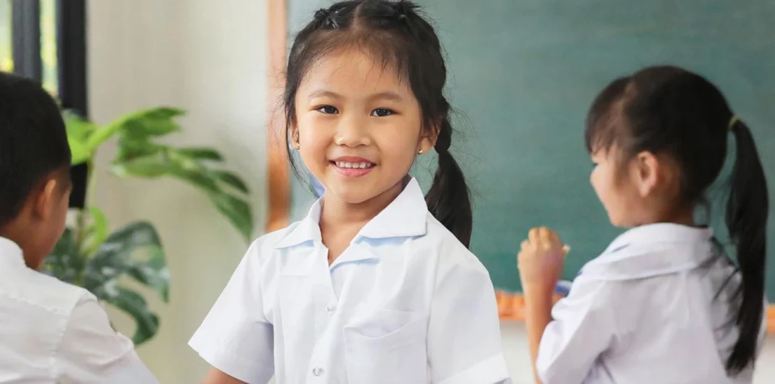 Primary school students in a classroom at a government school in Singapore, engaging in learning activities.