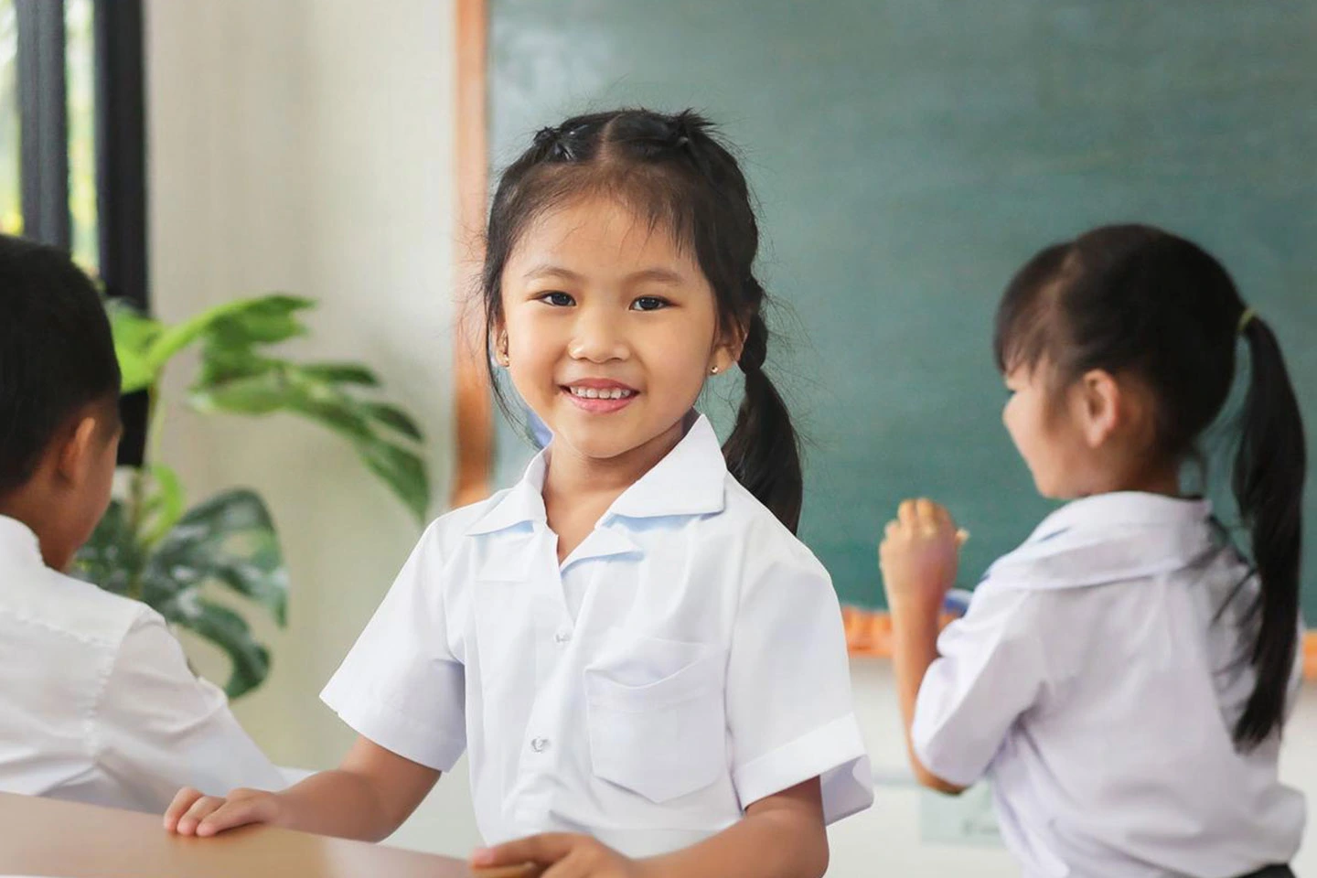 Primary school students in a classroom at a government school in Singapore, engaging in learning activities.