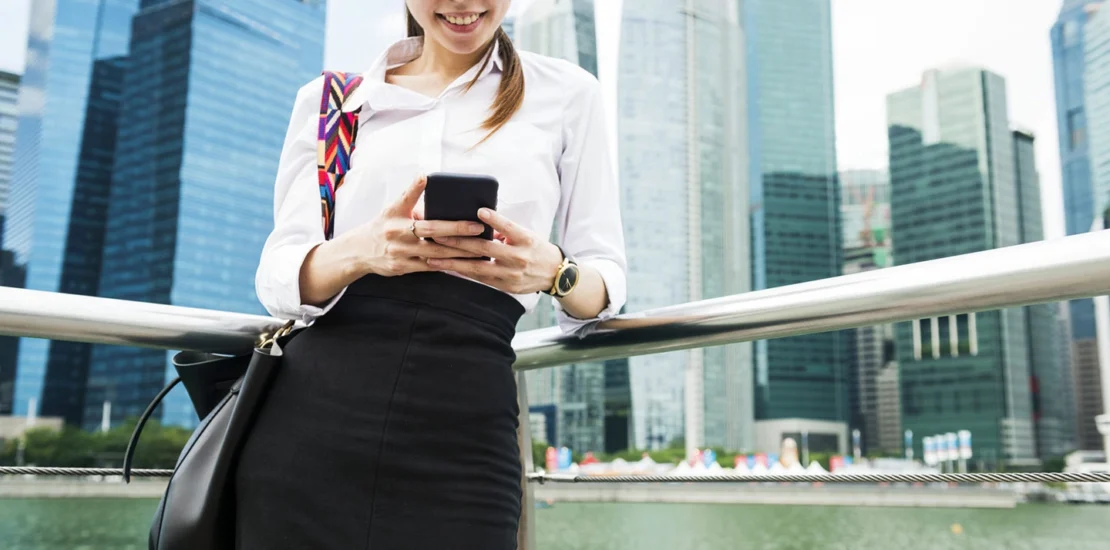 Professional woman in work attire in Singapore’s business district, representing successful visa and PR application.