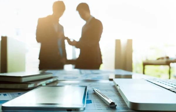 Team partners collaborating in an office setting for Singapore Employment Pass application.